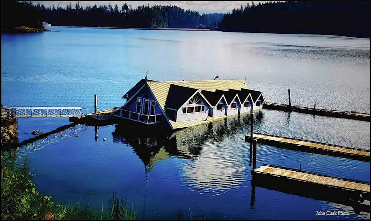 Abandoned sinking barge with lodge on it is being removed from Quadra Island