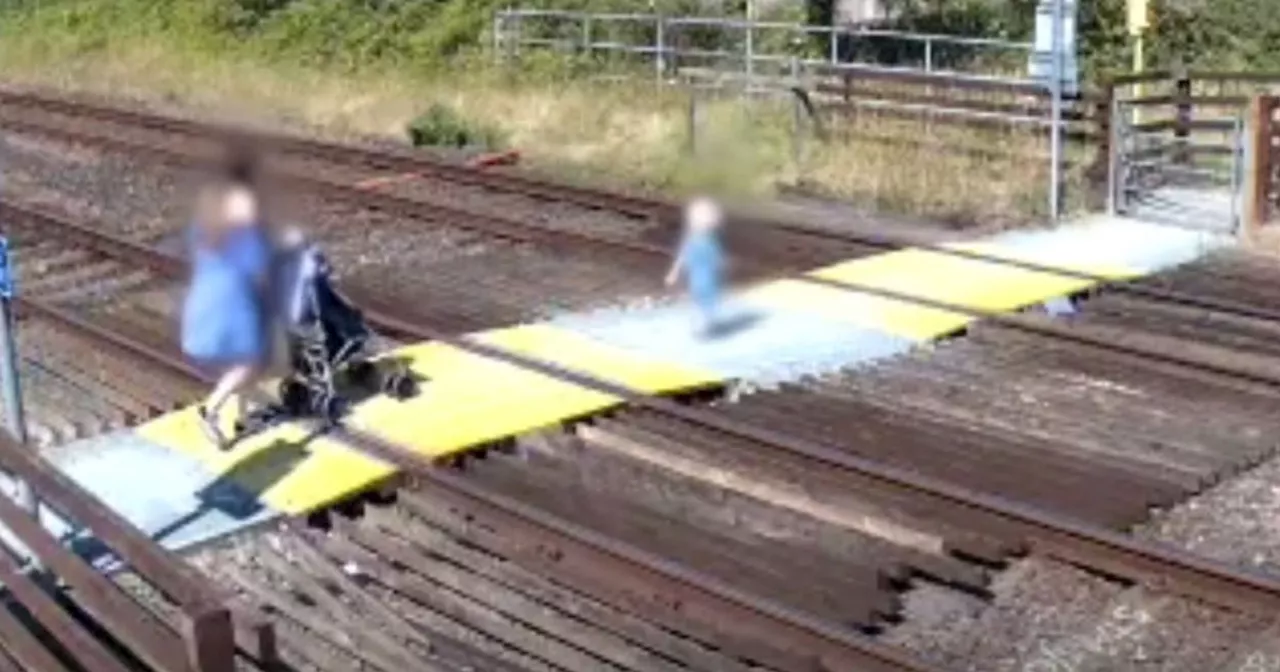 Terrifying moment toddler walks onto railway track in front of oncoming train