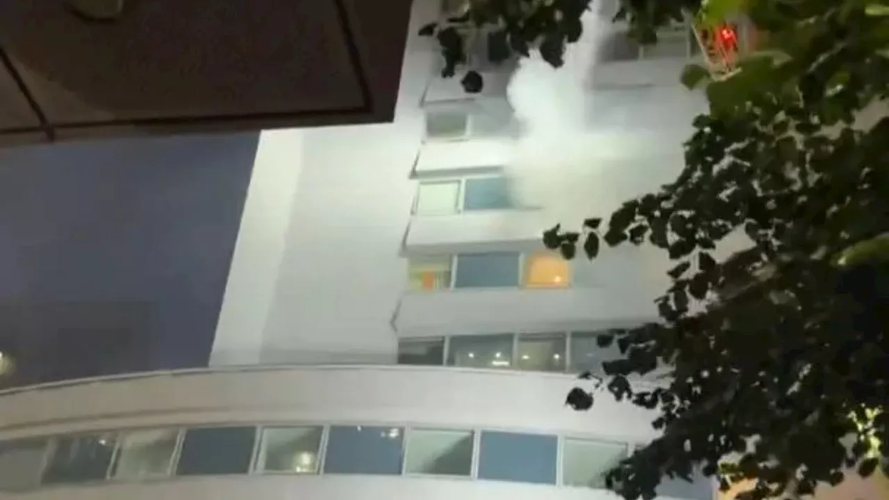 Terrifying moment blaze erupts in block of flats as 60 firefighters rush to tackle flames & helpless...