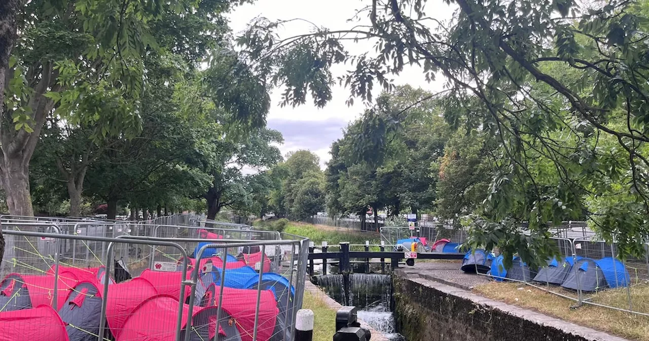 30 asylum seeker tents pitched along Grand Canal as protesters pull down fencing for second time