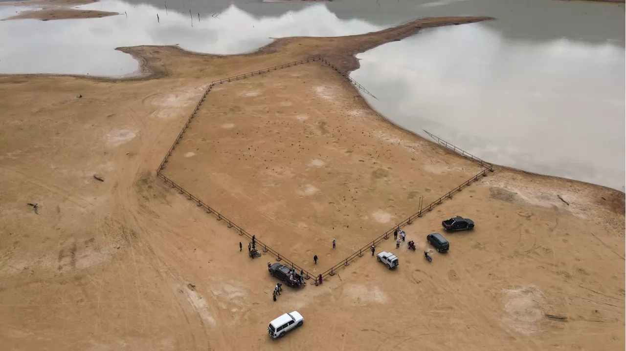 Old cemetery emerges as Pedu Lake waters recede