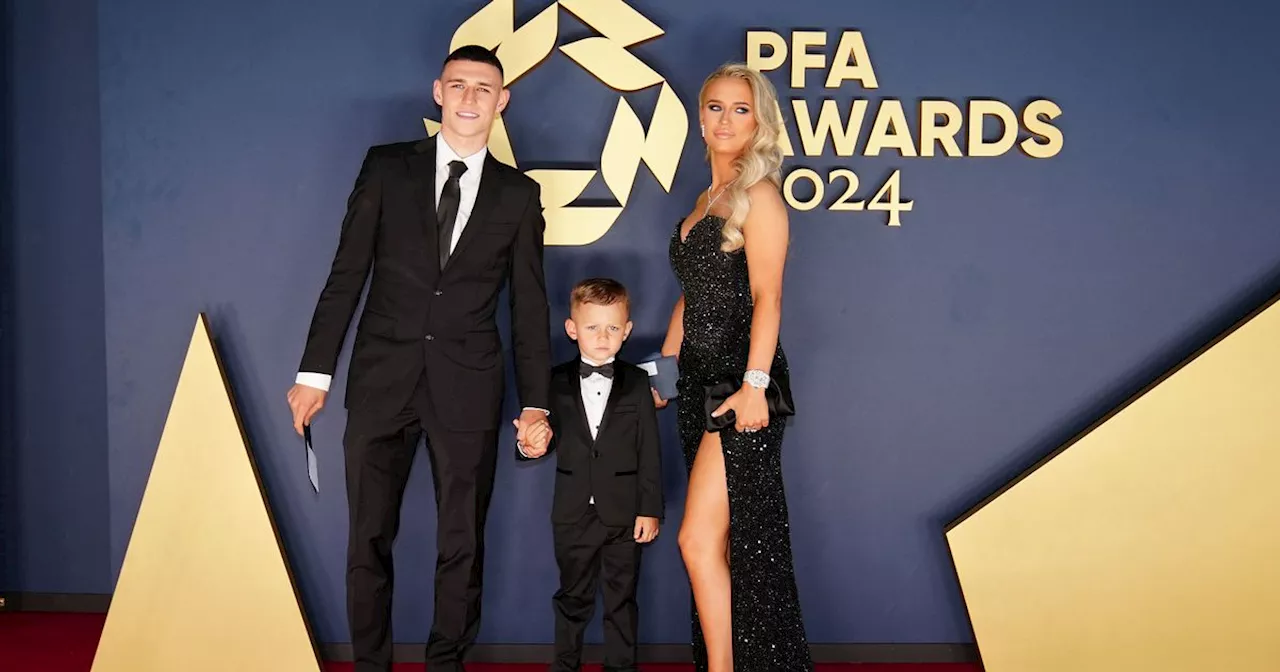 Phil Foden twins in black tie with his son on red carpet at PFA Awards