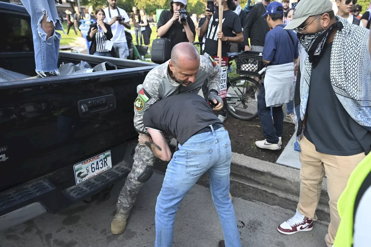 Some protesters tear down security fence as thousands march outside Democratic National Convention