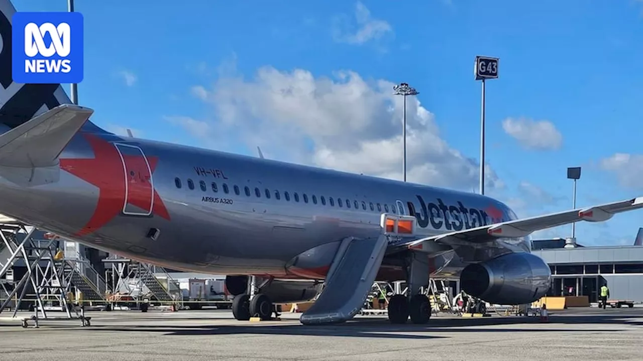 Jetstar passenger arrested after opening plane's emergency exit door at Melbourne Airport