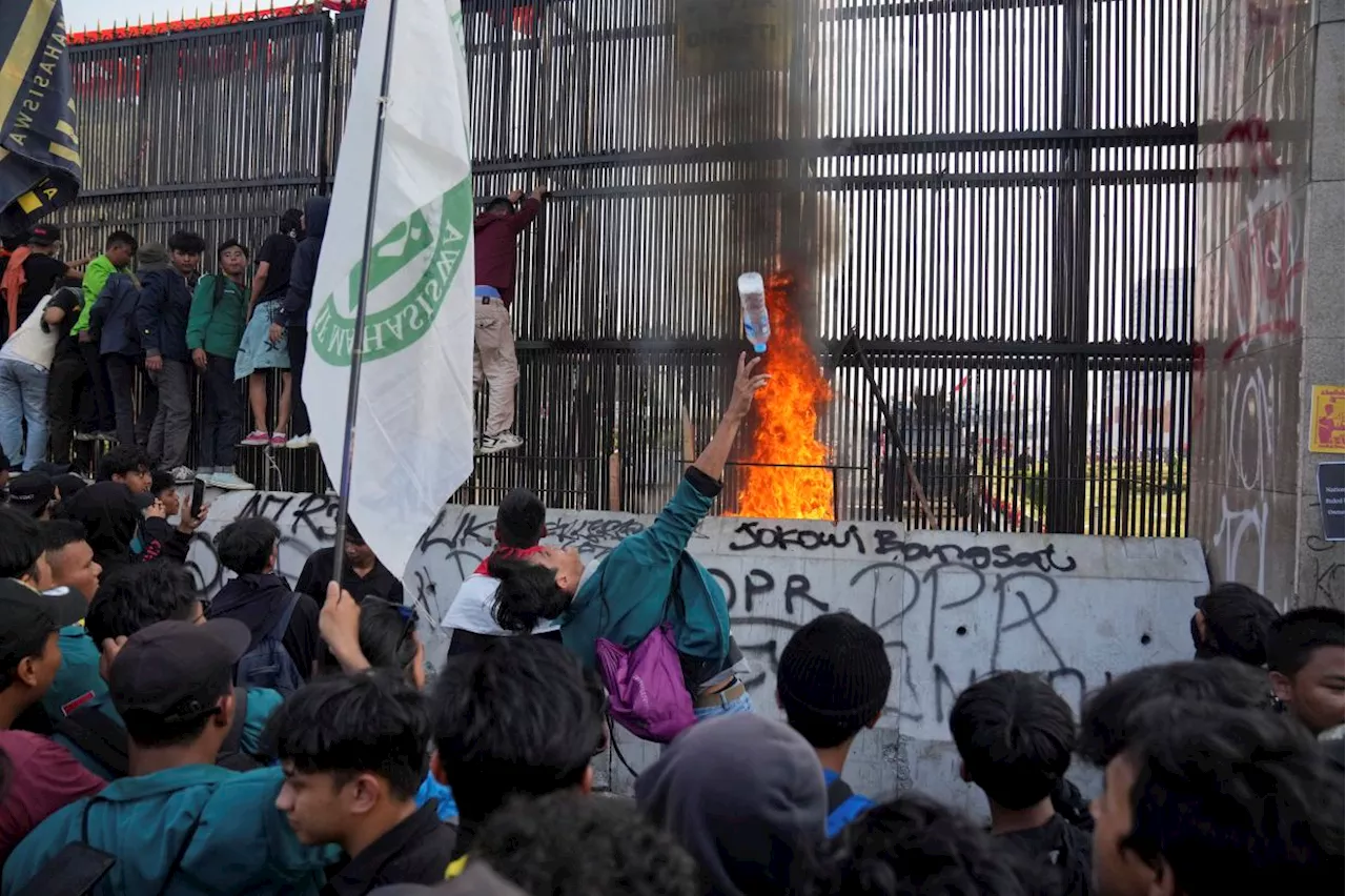 Security forces fire water cannon at protesters outside Indonesia's parliament building