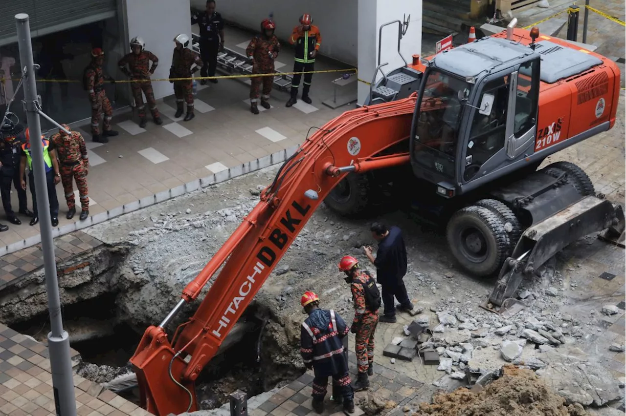 'Please save my mother,' says son of sinkhole victim