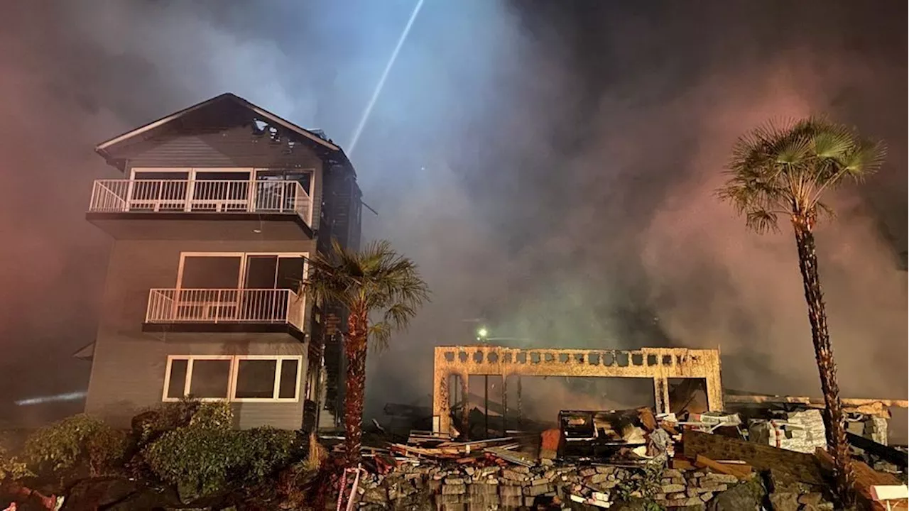 Firefighters extinguish flames at Seattle home under construction with downed power lines