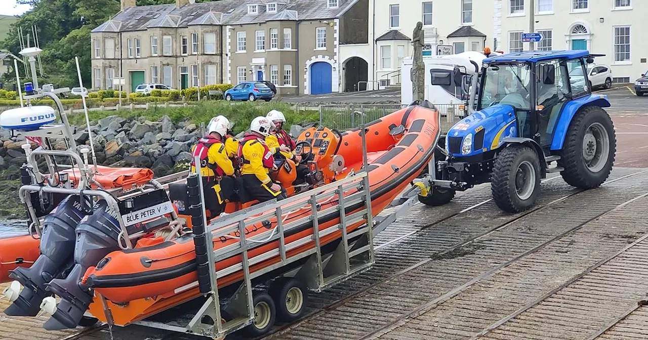 Three young adults and two dogs rescued after being cut off by the tide