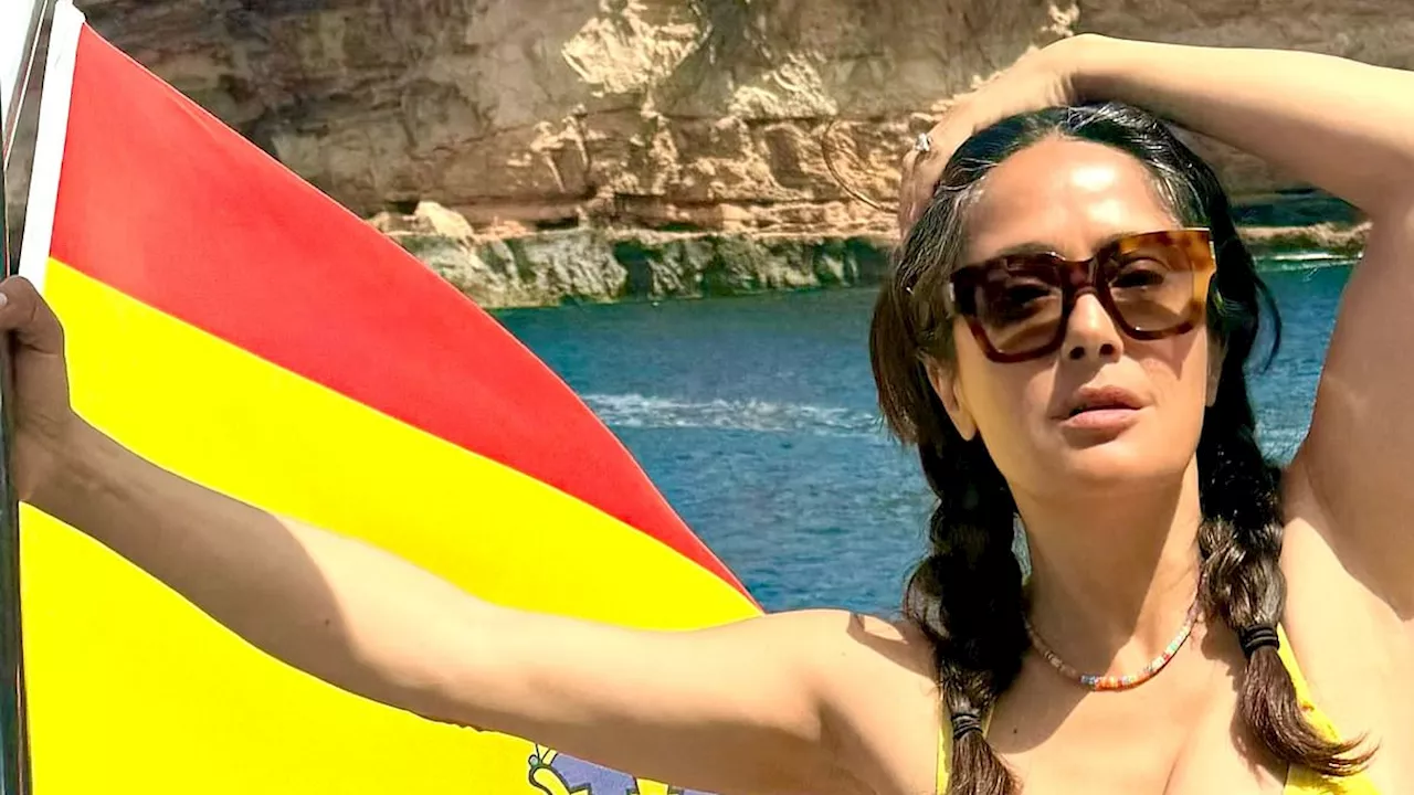 Salma Hayek puts on a busty display in bright yellow bikini in Ibiza as she jokes about her 'white...