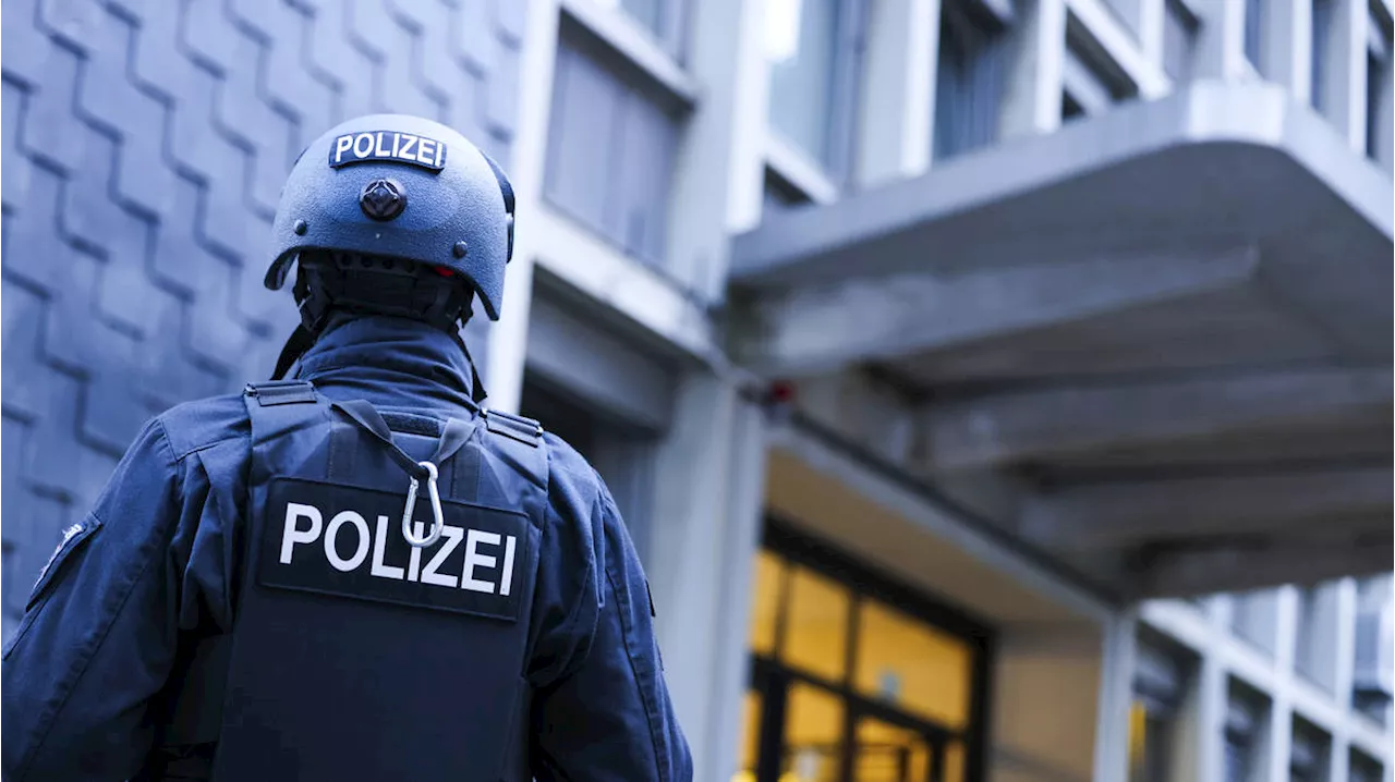 Police detain a suspect in the German knife attack that killed three