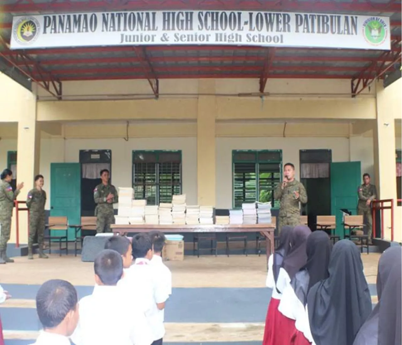 21IB distributes books to a school in Sulu