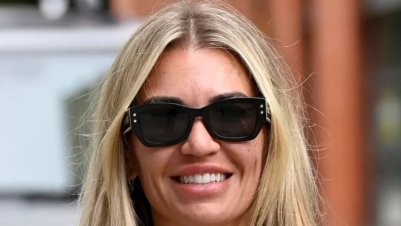 Christine McGuinness puts on a busty display in a plunging grey trouser set after thrilling fans...