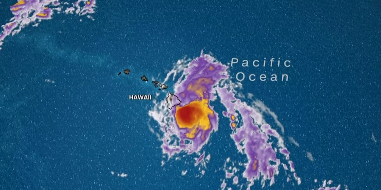 Hone weakens to tropical storm while sweepng past Hawaii, dumping enough rain to ease wildfire fears