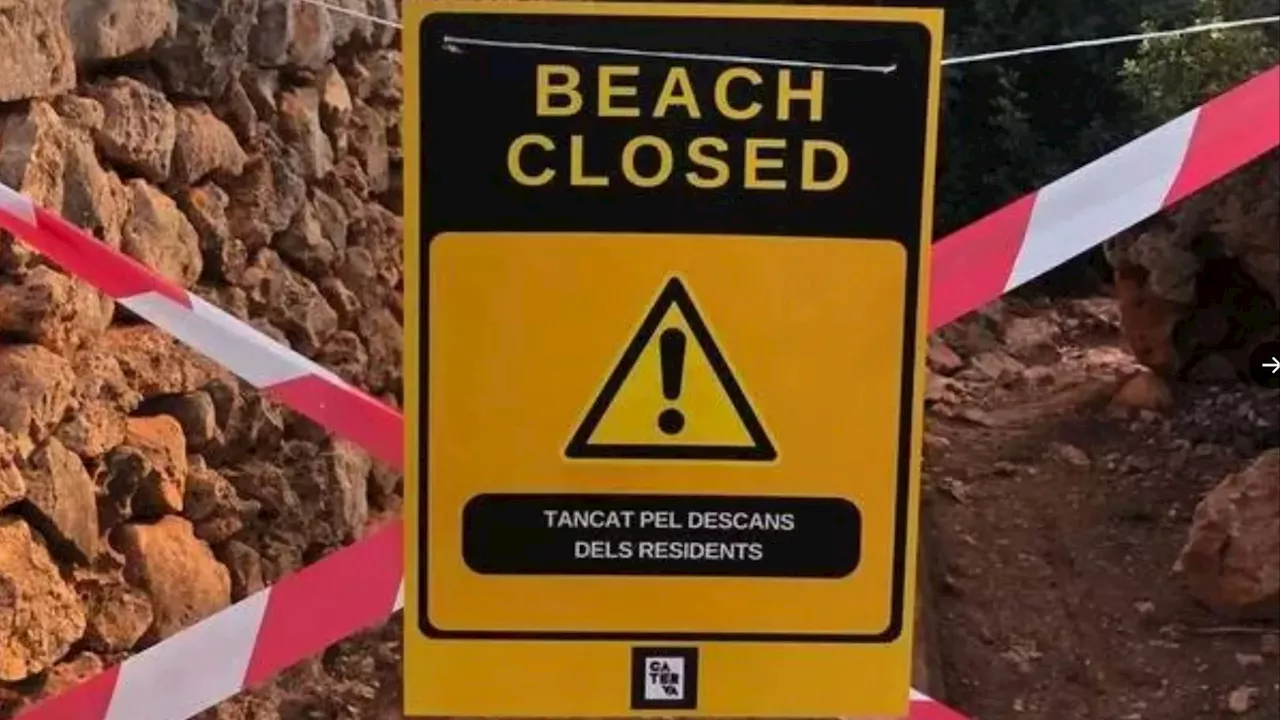 Anti-tourist fanatics tape off beaches with FAKE closure signs in Majorca to stop holidaymakers visiting...