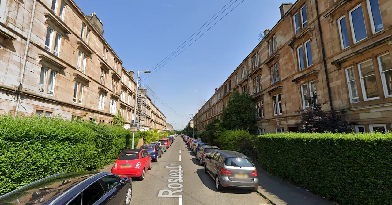 Woman rushed to hospital after 'two yobs break into Glasgow flat block'