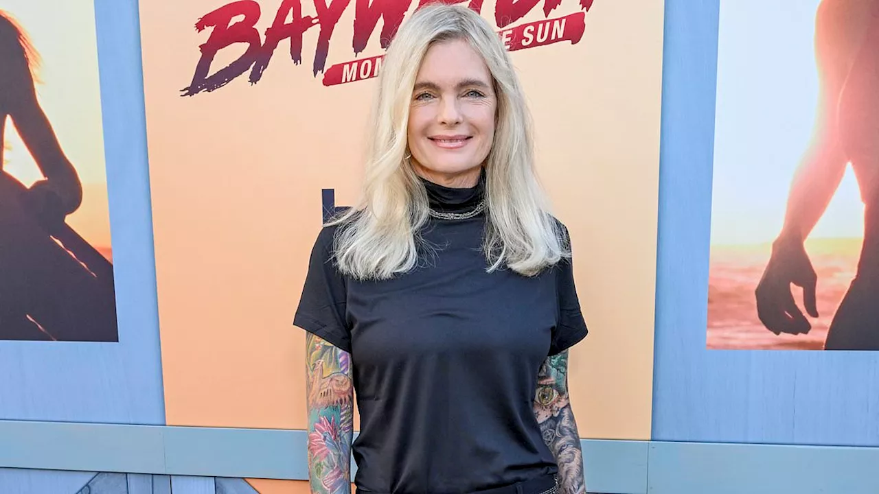 Baywatch vet Erika Eleniak, 54, reveals FULLY tattooed arms in rare sighting at Los Angeles event