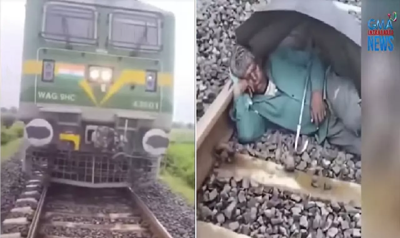 Tren, napahinto dahil sa lalaking mahimbing na natutulog sa riles na may payong pa sa India