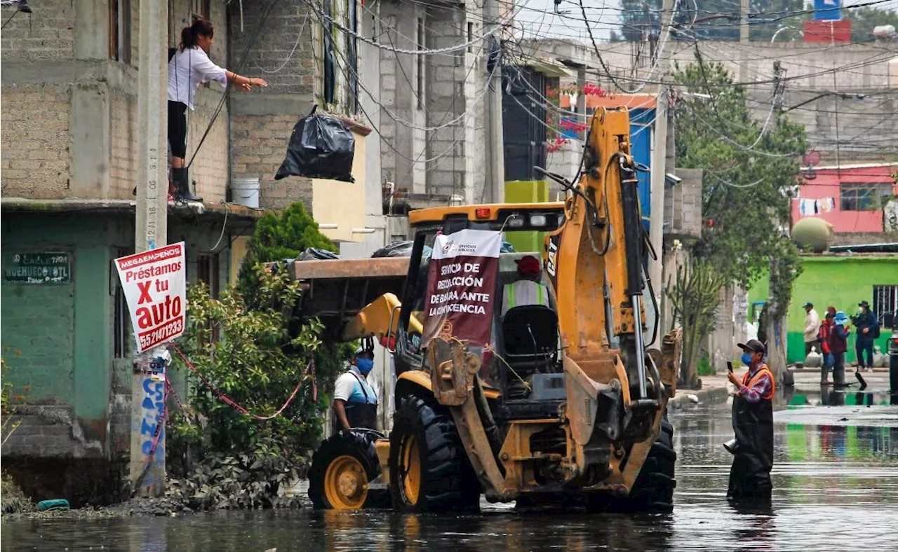 Usan retroexcavadora para sacar basura de la anegación