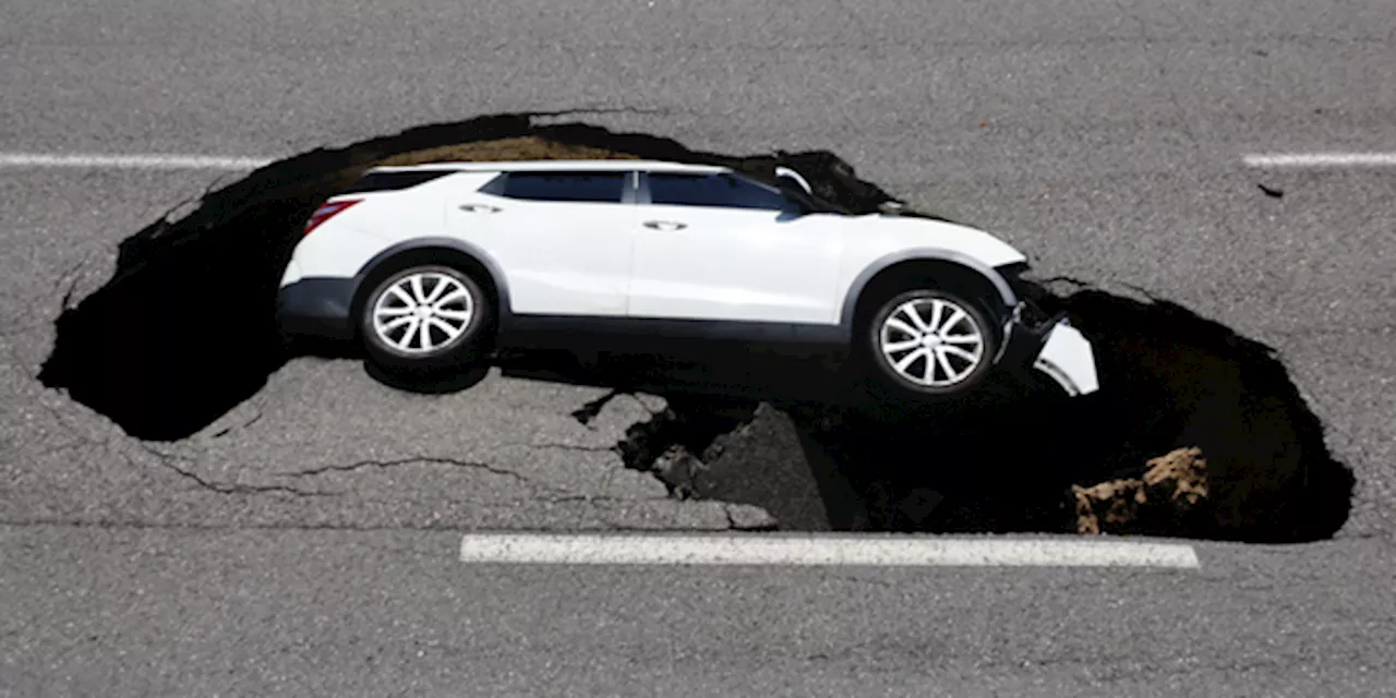 2 People Injured After Sinkhole Appears In Seoul And Swallows Car