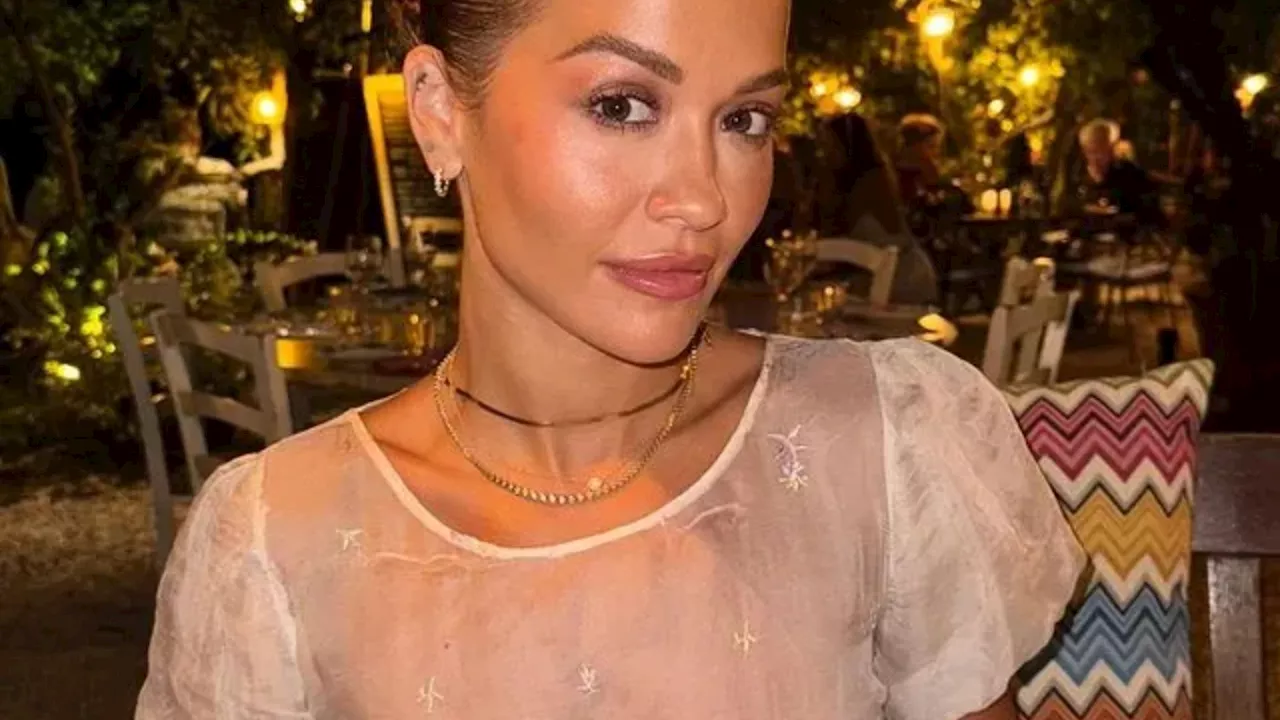 Rita Ora goes braless in sheer top as she poses during dinner date...