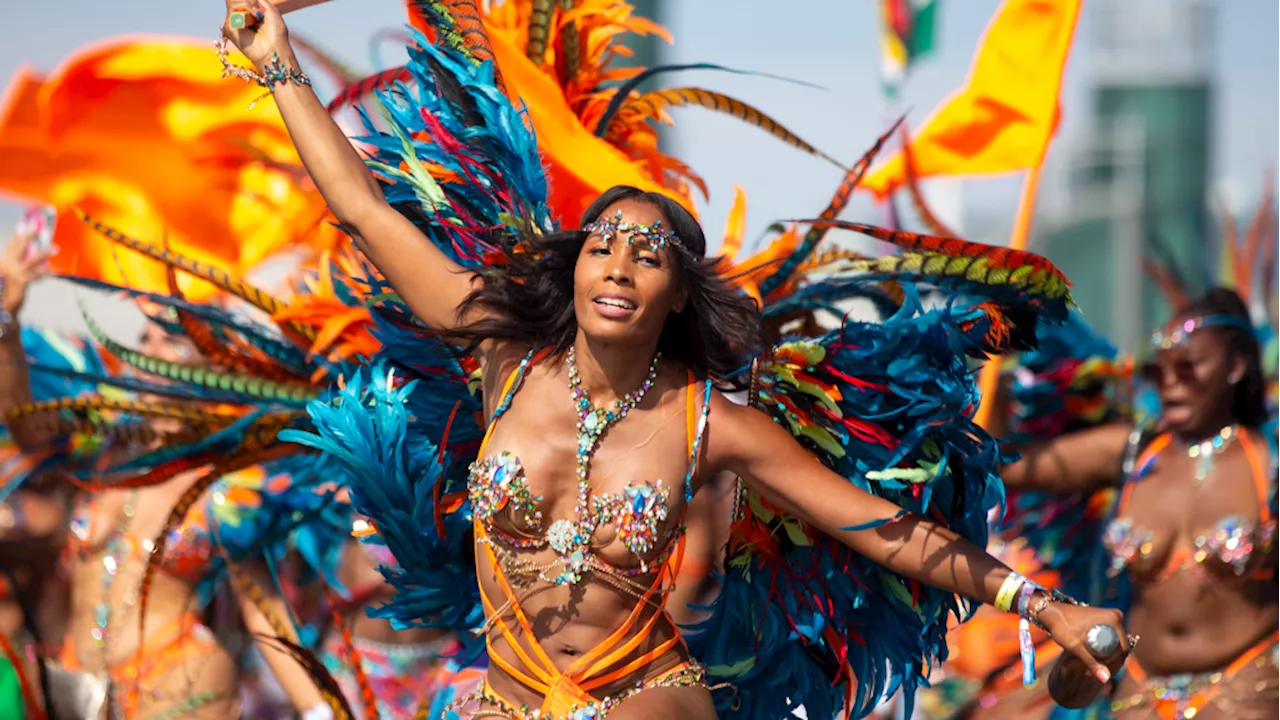 Revellers dance in colourful ensembles at Caribbean Carnival Grand Parade