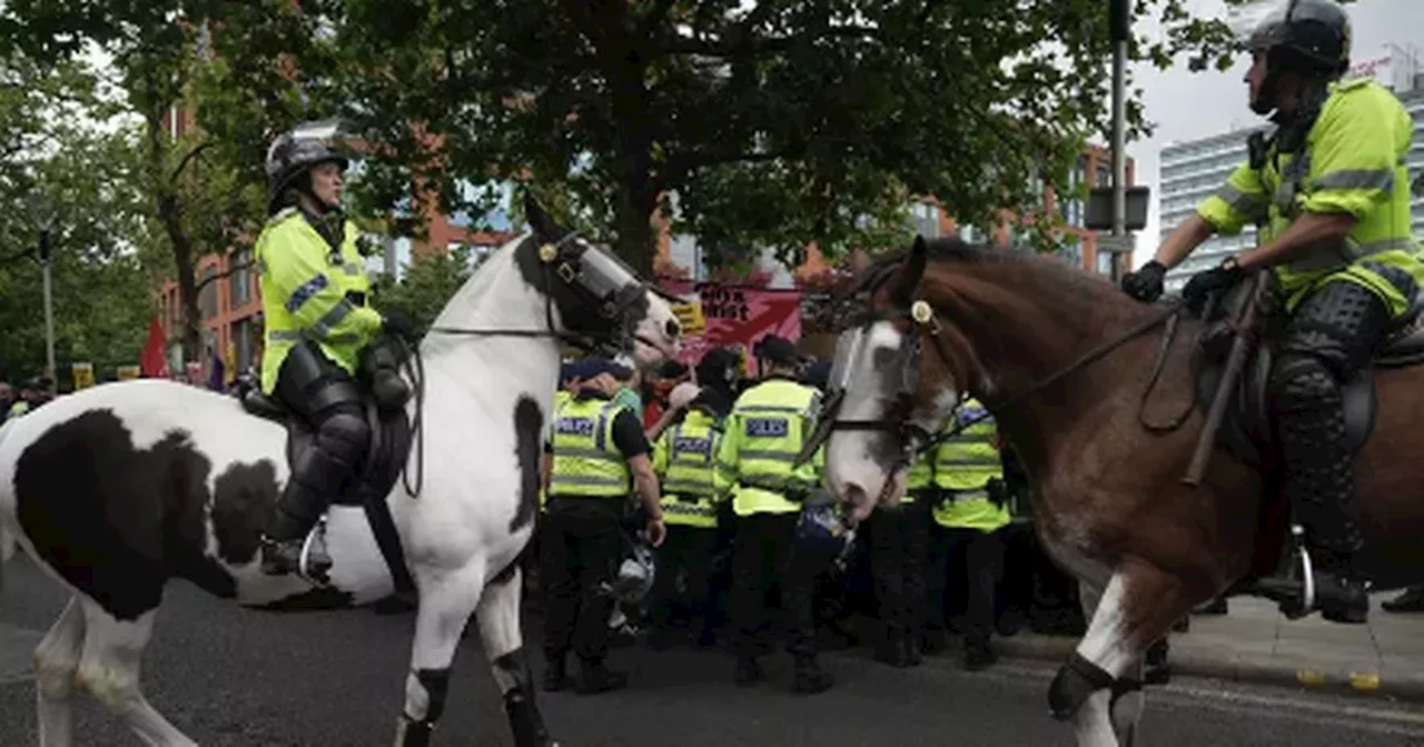 Police issue warning as hundreds of demonstrators descend on Manchester