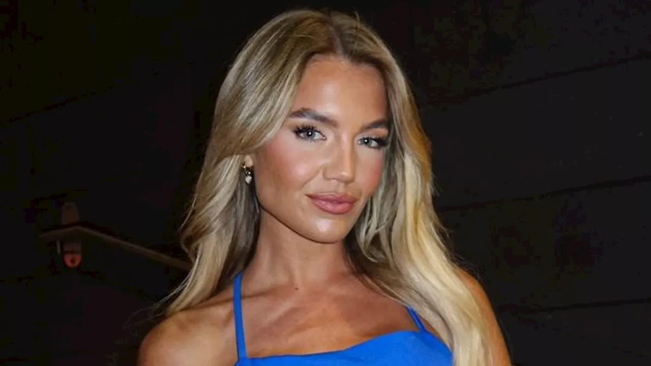 Molly Smith flashes her sideboob in a racy backless blue crop top and miniskirt while posing for...