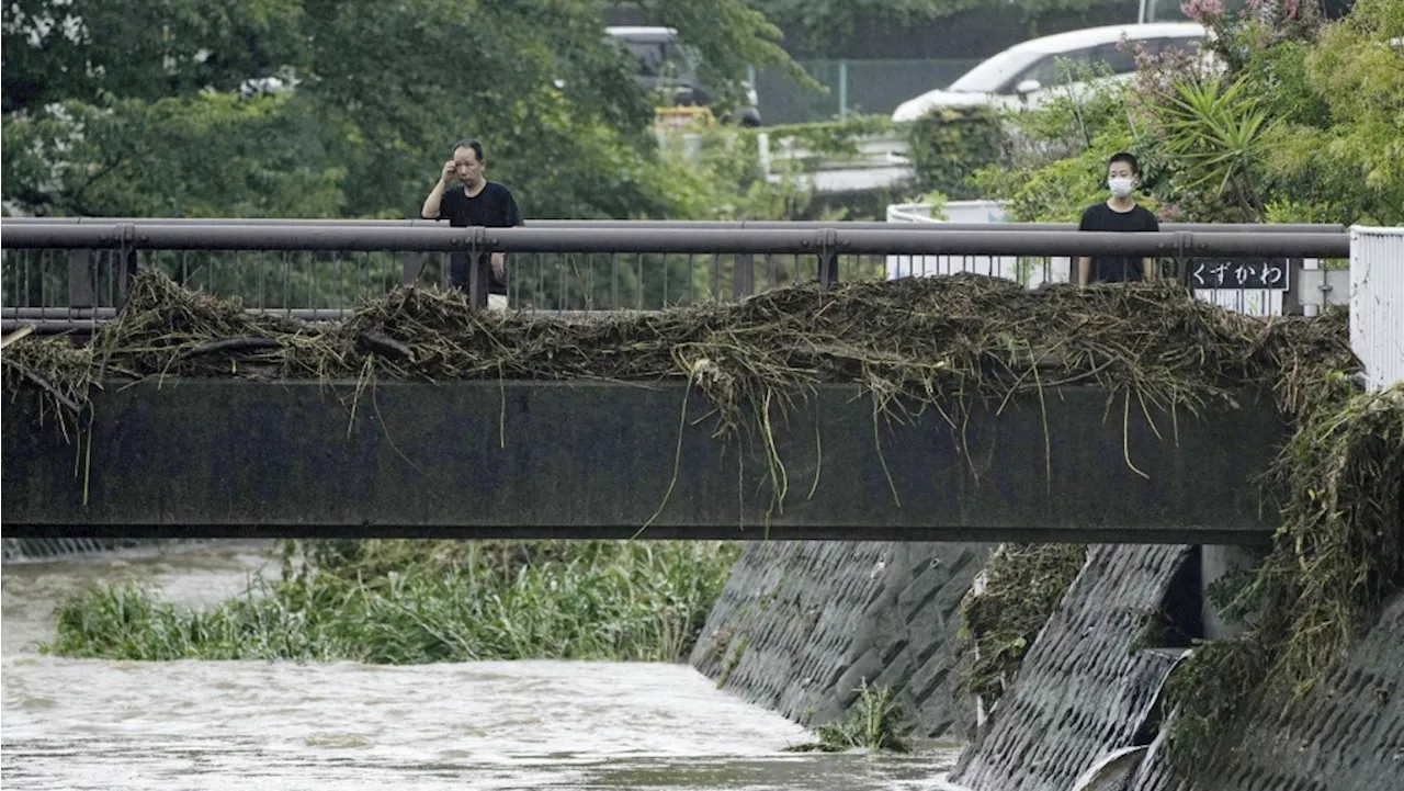 Slow tropical storm dumps heavy rain around Tokyo after causing floods in southern Japan