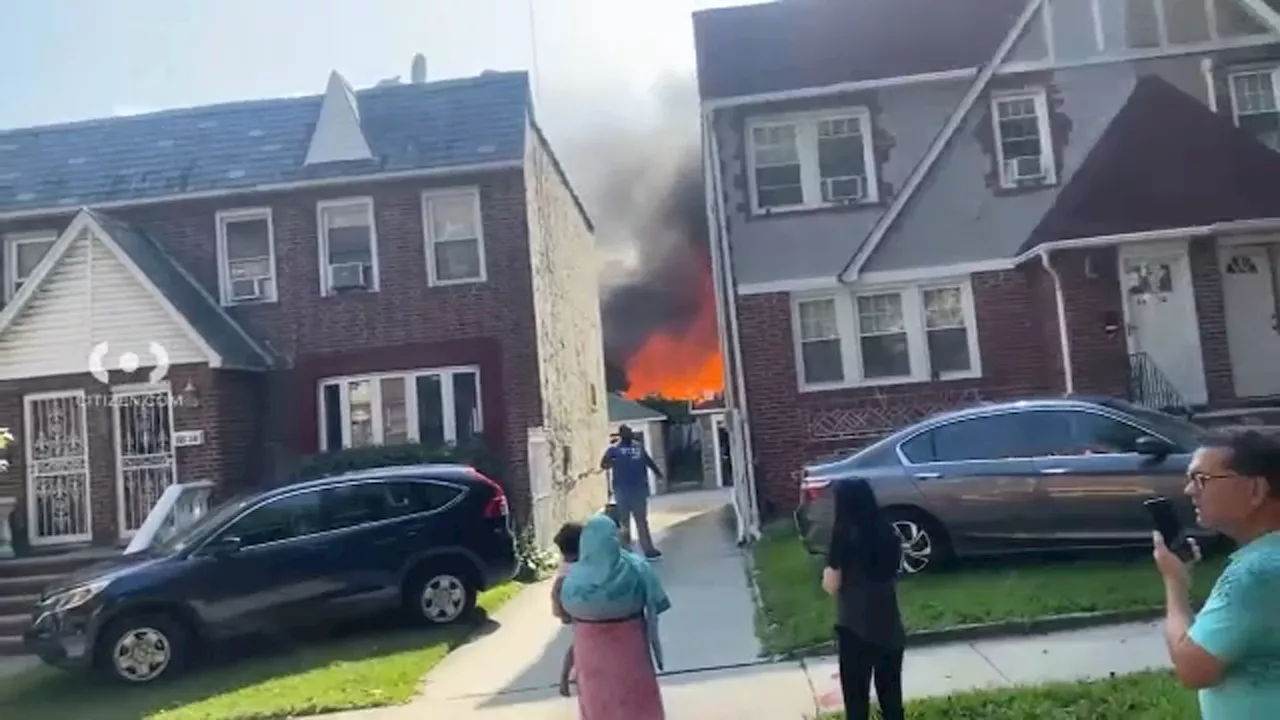 11 firefighters among 14 injured after flames tear through Queens homes