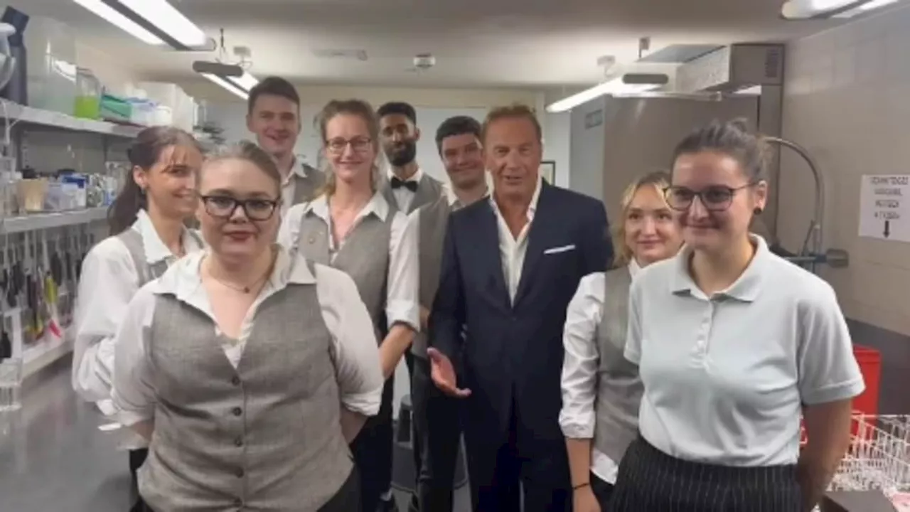 Kevin Costner visits kitchen staff backstage during the Berlin premiere of his western Horizon......