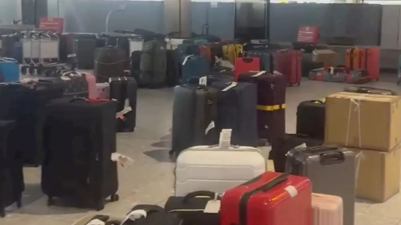 Shock photos reveal mountains of luggage at Heathrow after dozens of British Airways flights cancelled...