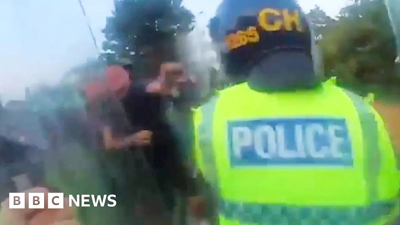 Moment police officer punched by protester during Southport riot