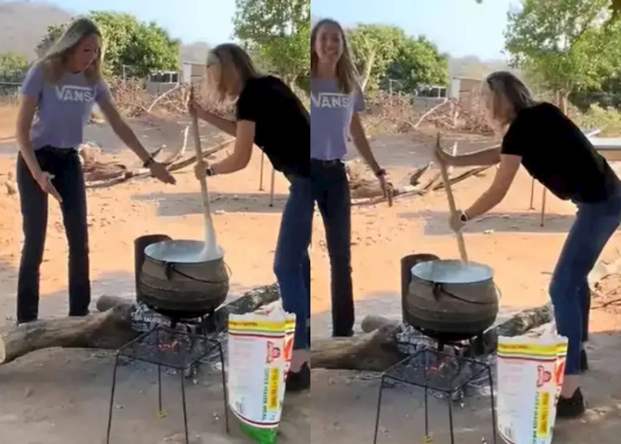 EISH WENA: Two white women stirring pap in a pot over open fire, impress SA