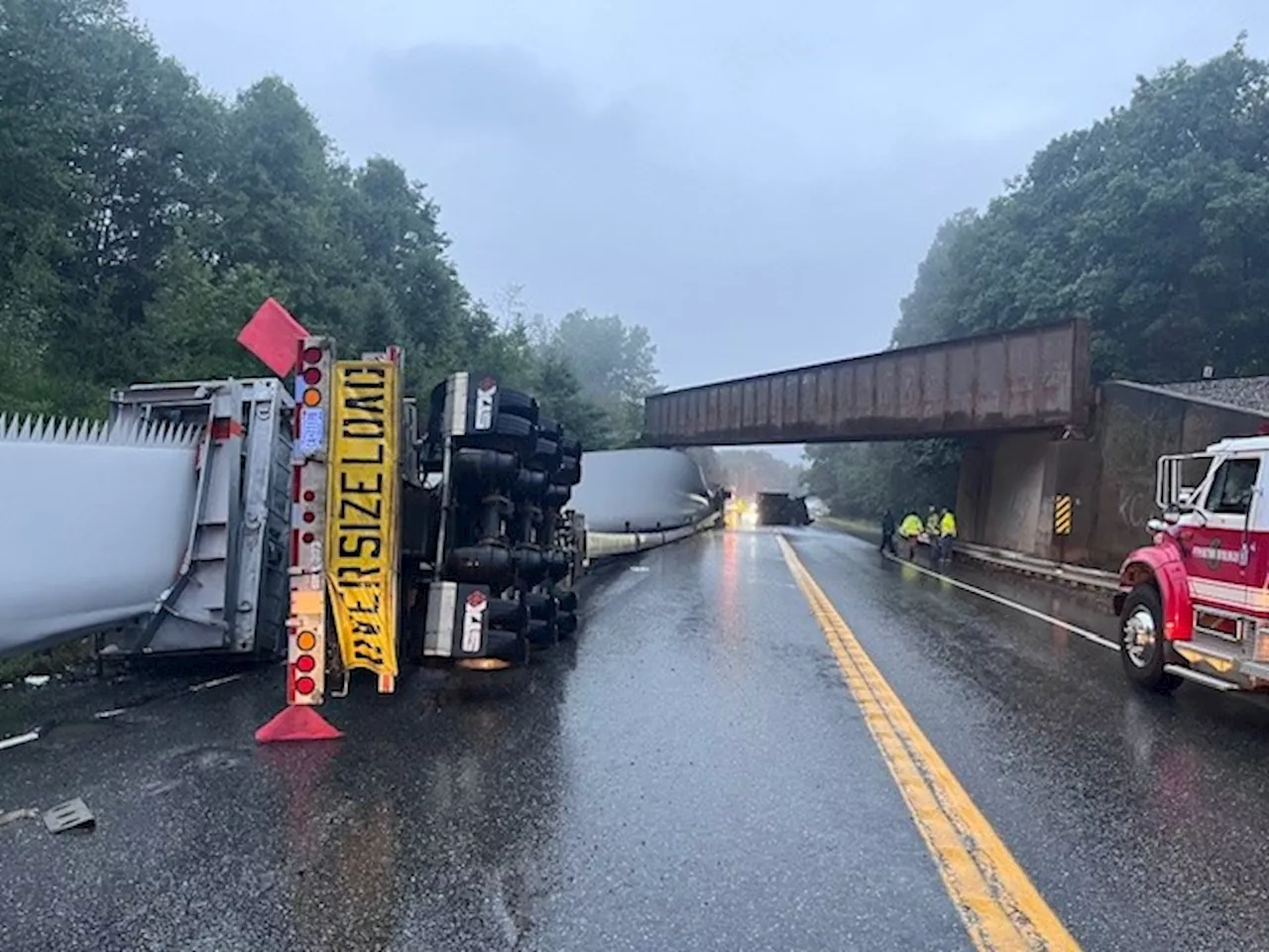 Tractor-trailer carrying windmill blade collides with railroad bridge in Maine