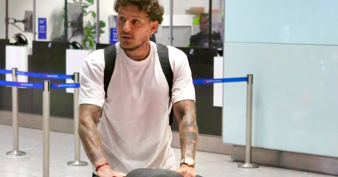 Katie Price's partner JJ Slater seen pushing suitcases after her airport arrest