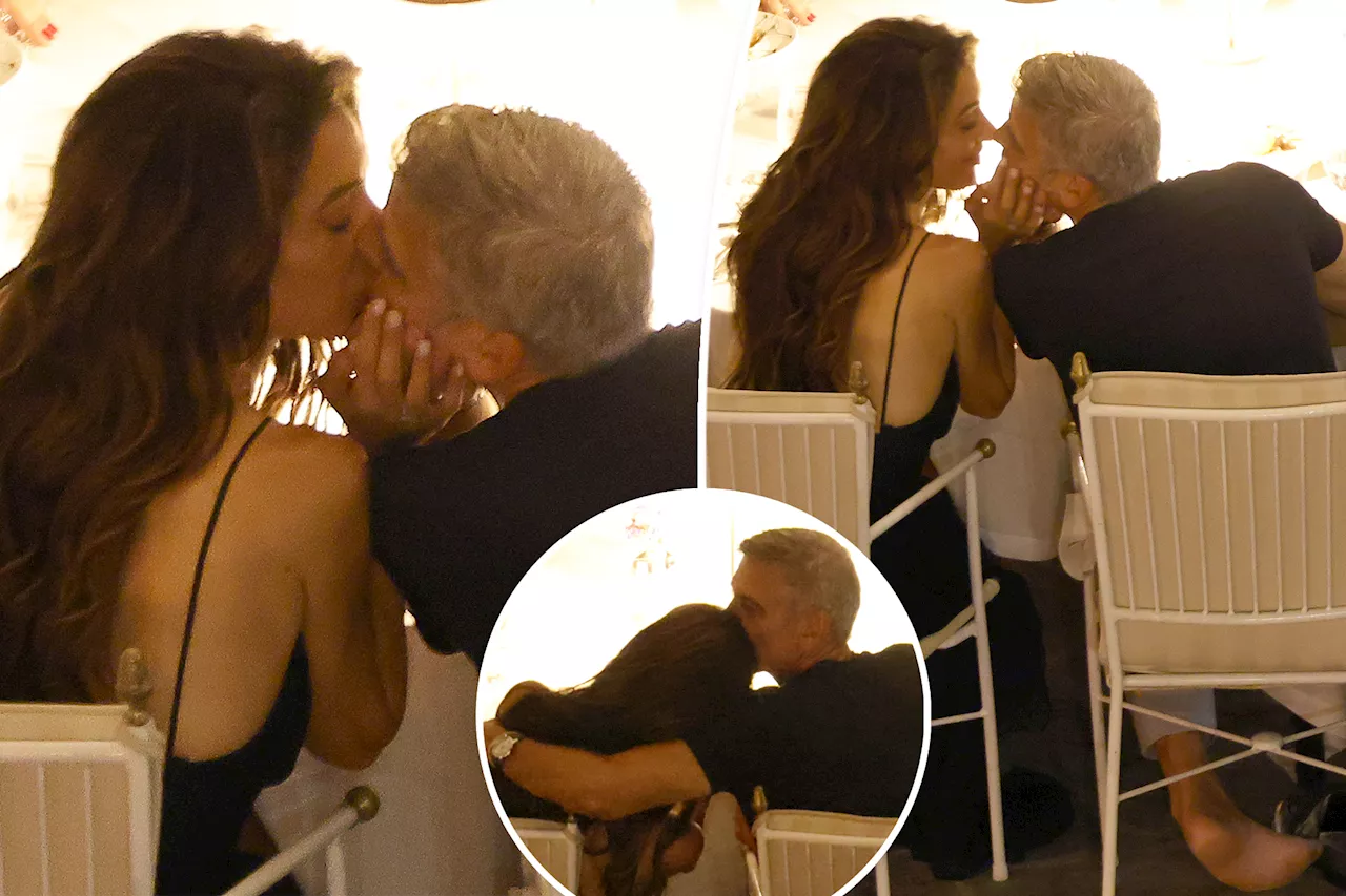 Shoeless George Clooney and wife Amal share a passionate kiss during dinner in Italy