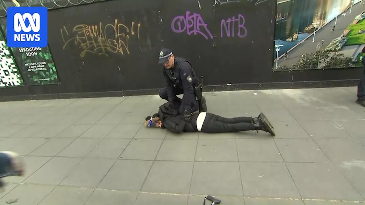 Live: Thousands of protesters disrupt Land Forces defence expo in Melbourne's CBD