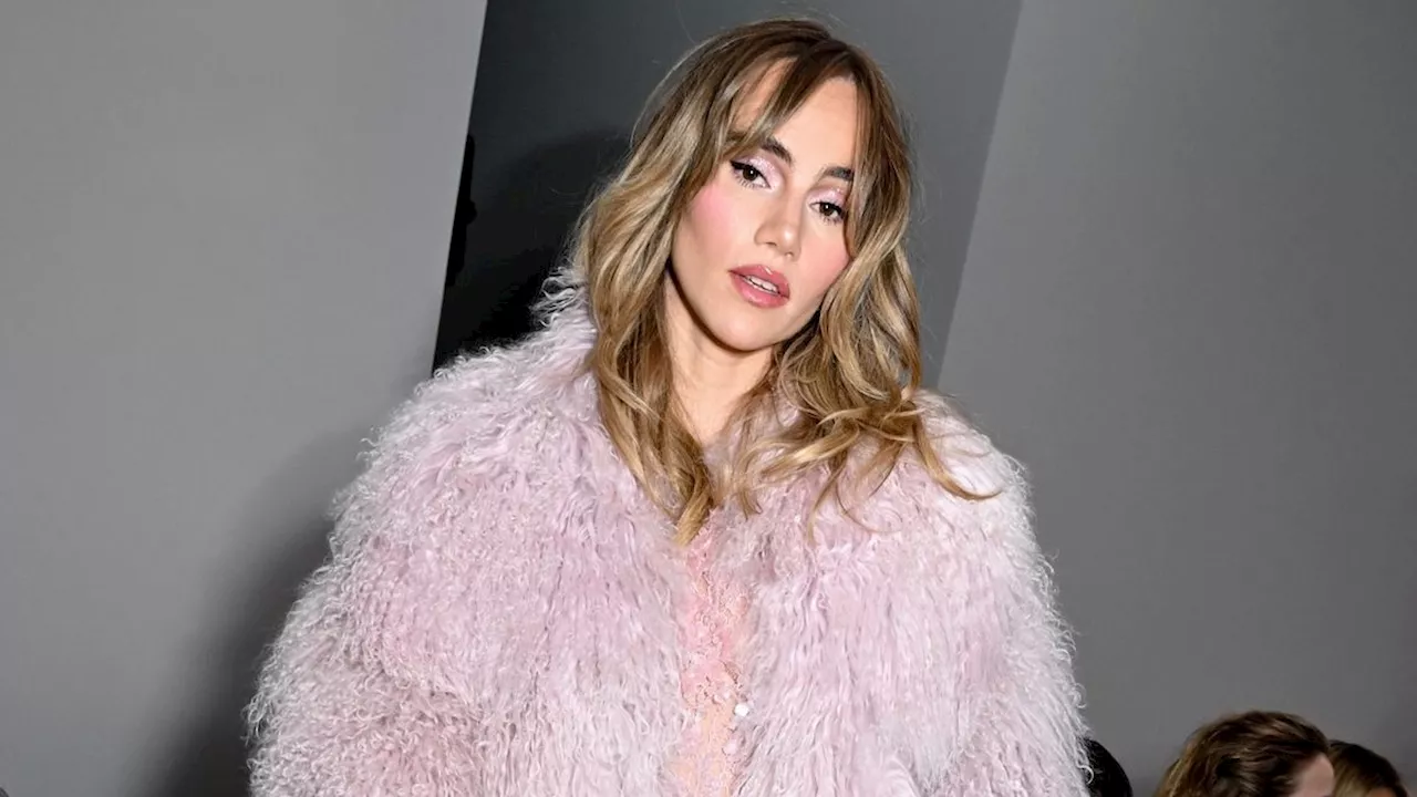 Suki Waterhouse Elevates Her Nearly-Naked Dress With a Giant Pink Personality Coat