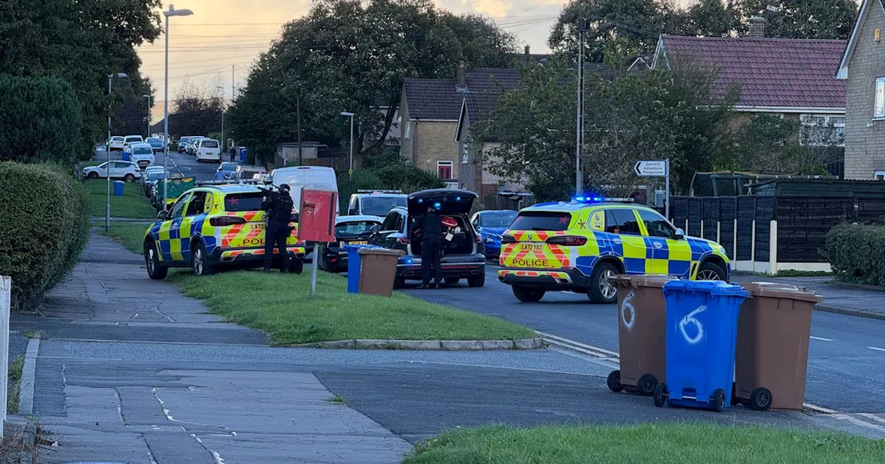 LIVE: Armed police descend on street and point guns at property