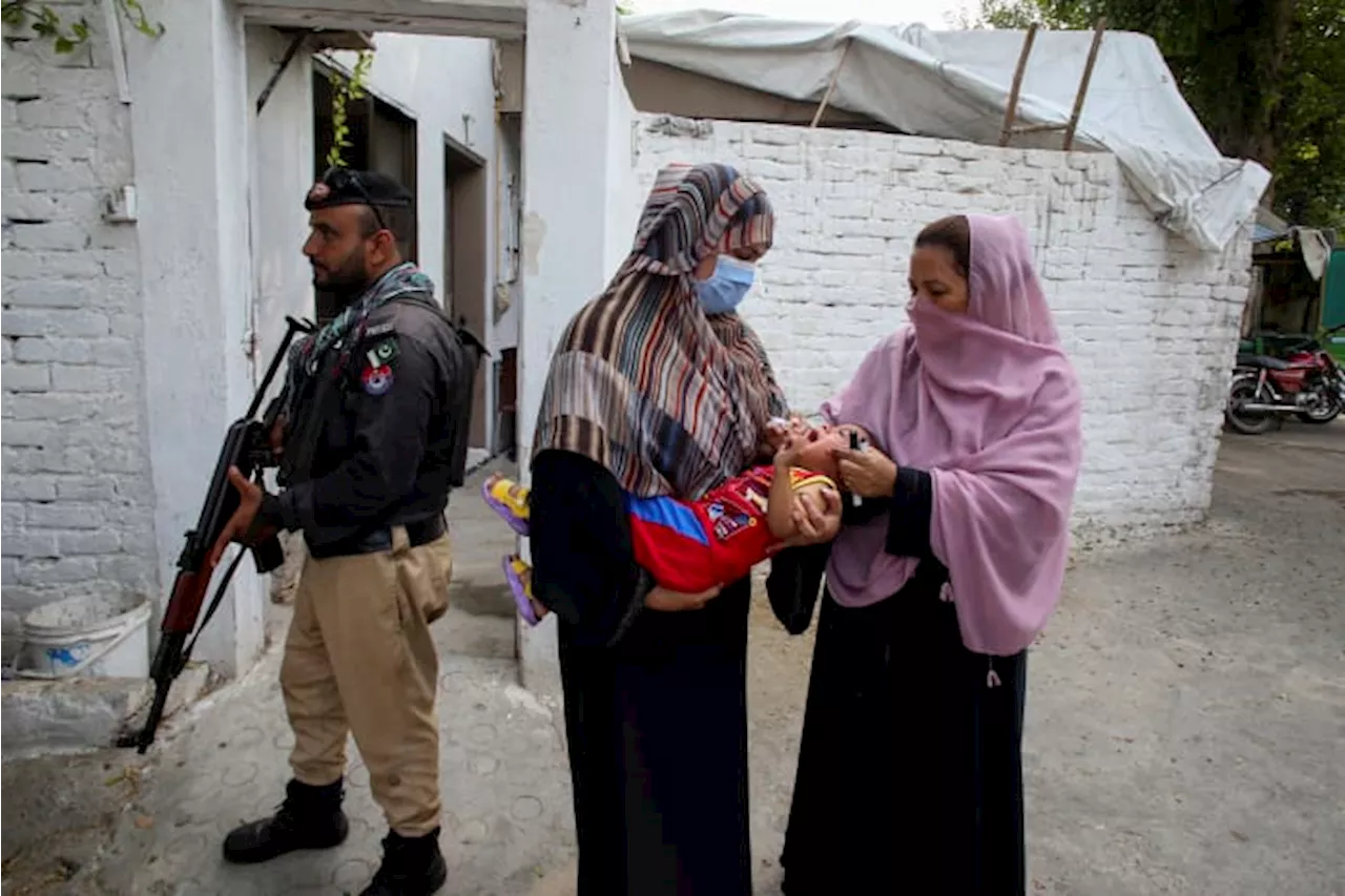 Gunmen on motorcycles kill a Pakistani policeman and a polio worker during a vaccination campaign