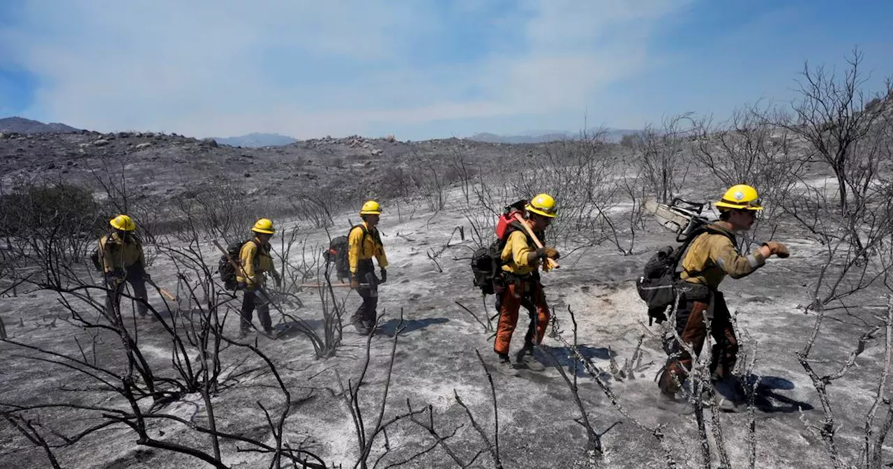 Wildfires in Southern California torch dozens of homes and force thousands to evacuate