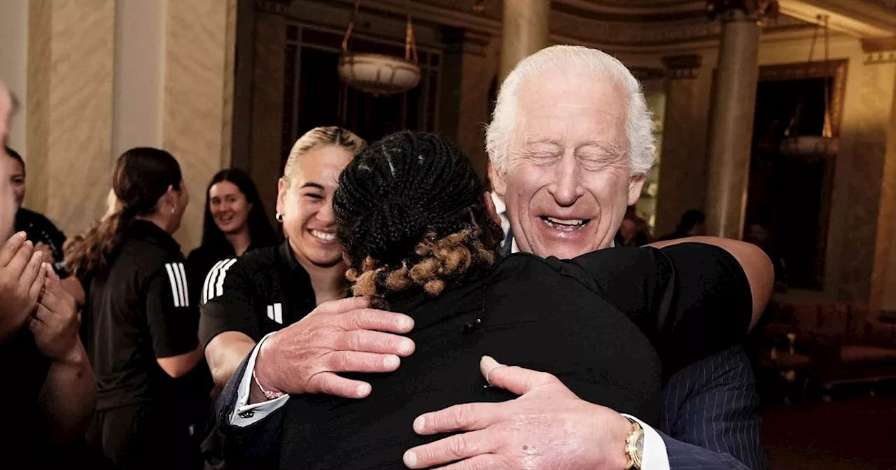 King Charles mobbed by female rugby players for hug and issues health warning