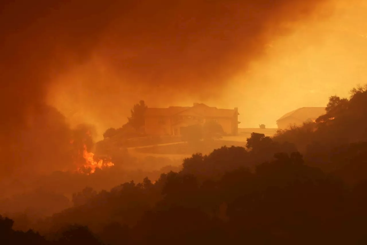 Los Angeles wildfire explodes, engulfing homes