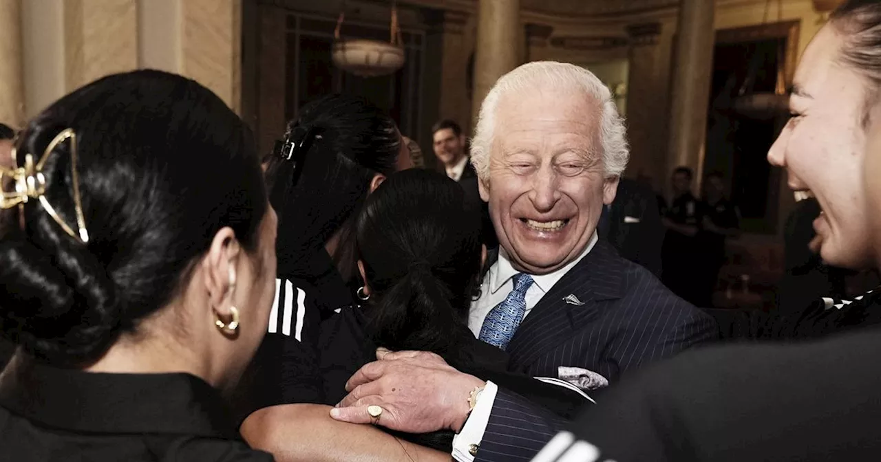 King Charles Receives Group Hug From Black Ferns Rugby Team During Buckingham Palace Visit