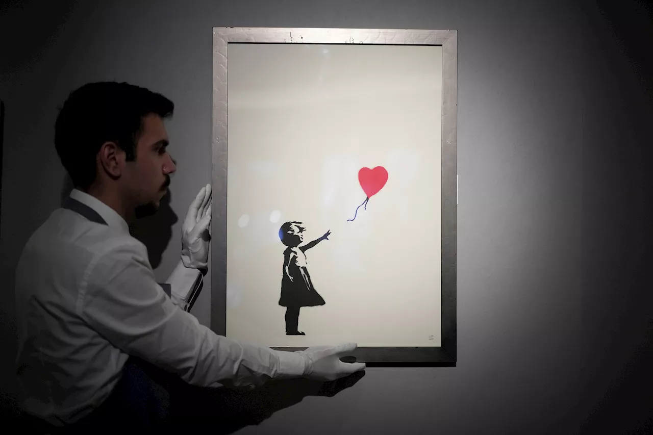 2 men charged with stealing a famous Banksy image from a London art gallery