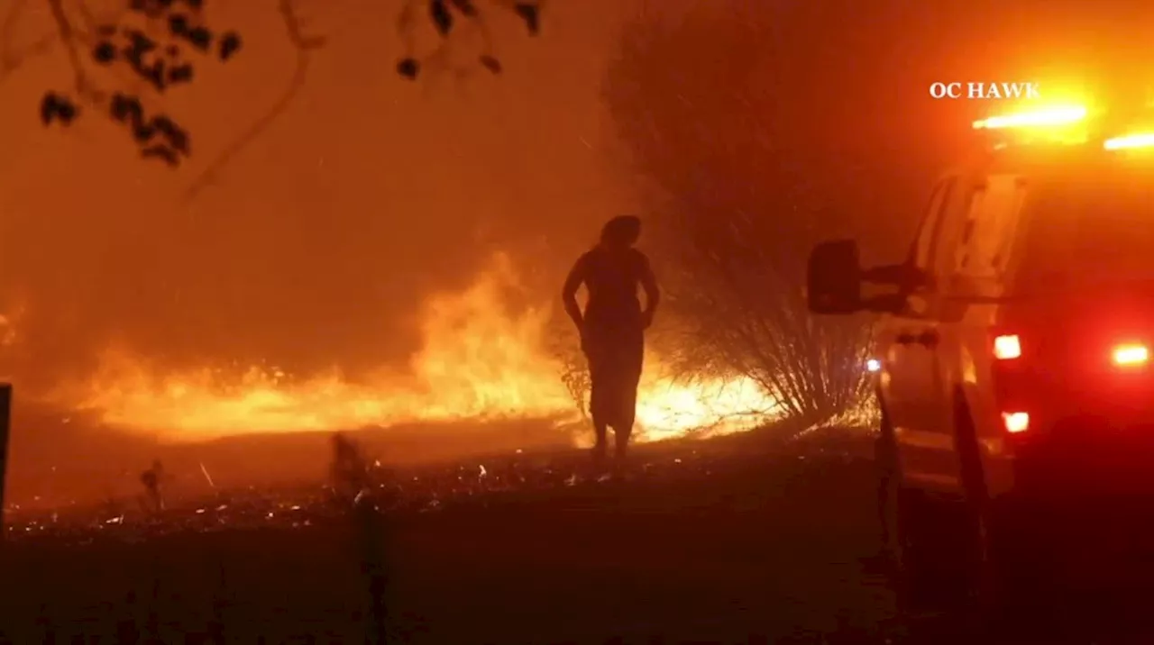 Video shows Cal Fire battalion chief rescues woman walking near Airport fire flames