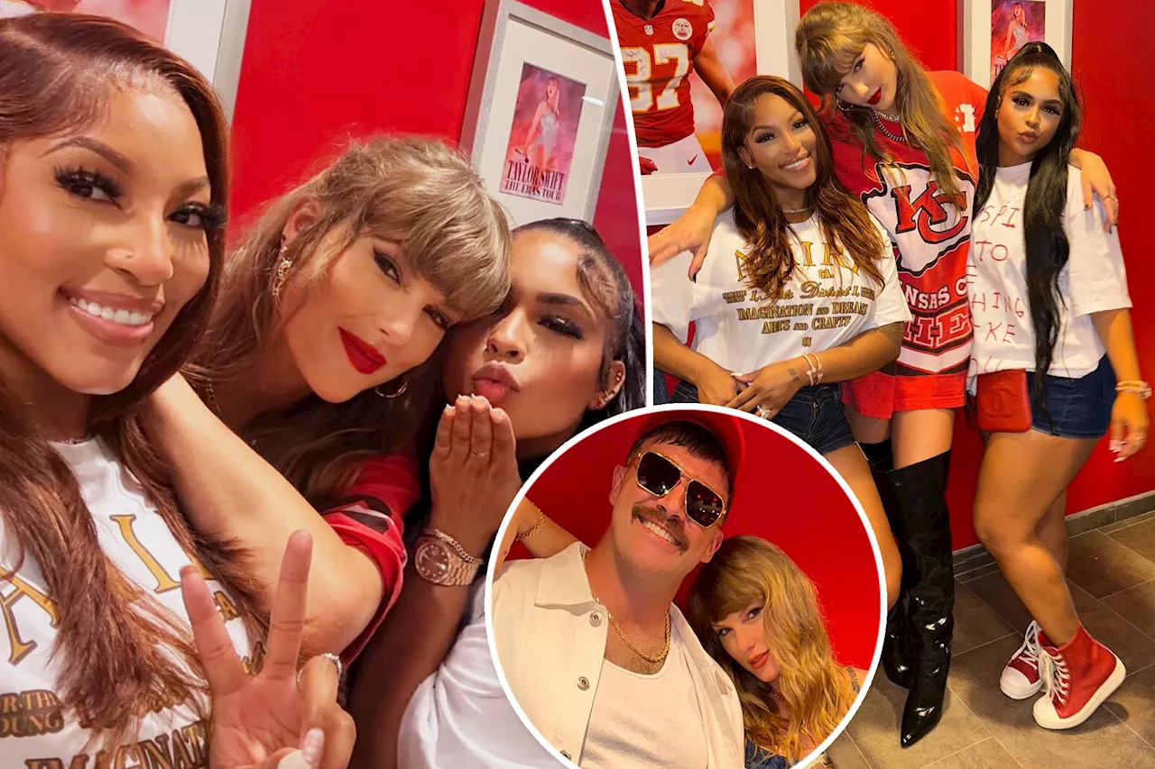 Taylor Swift poses in front of Eras Tour poster in Travis Kelce's Chiefs suite