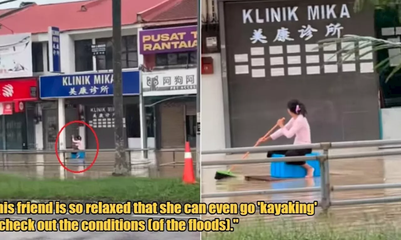 WATCH: Woman Hilariously Uses a Squeegee to Row Her Makeshift Raft Down Flooded Penang Road