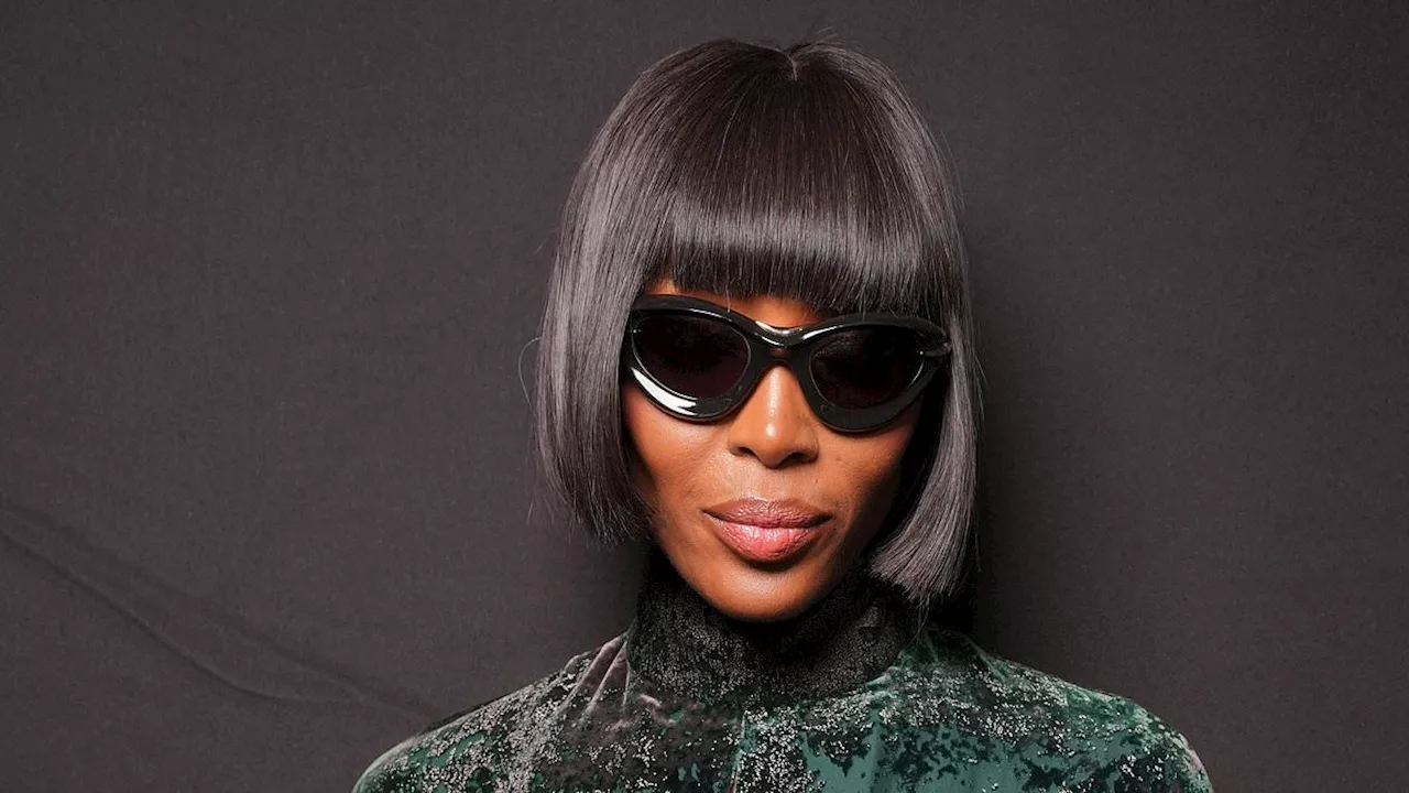 Naomi Campbell lives up to her supermodel status as she wows in a green crushed velvet dress at the...