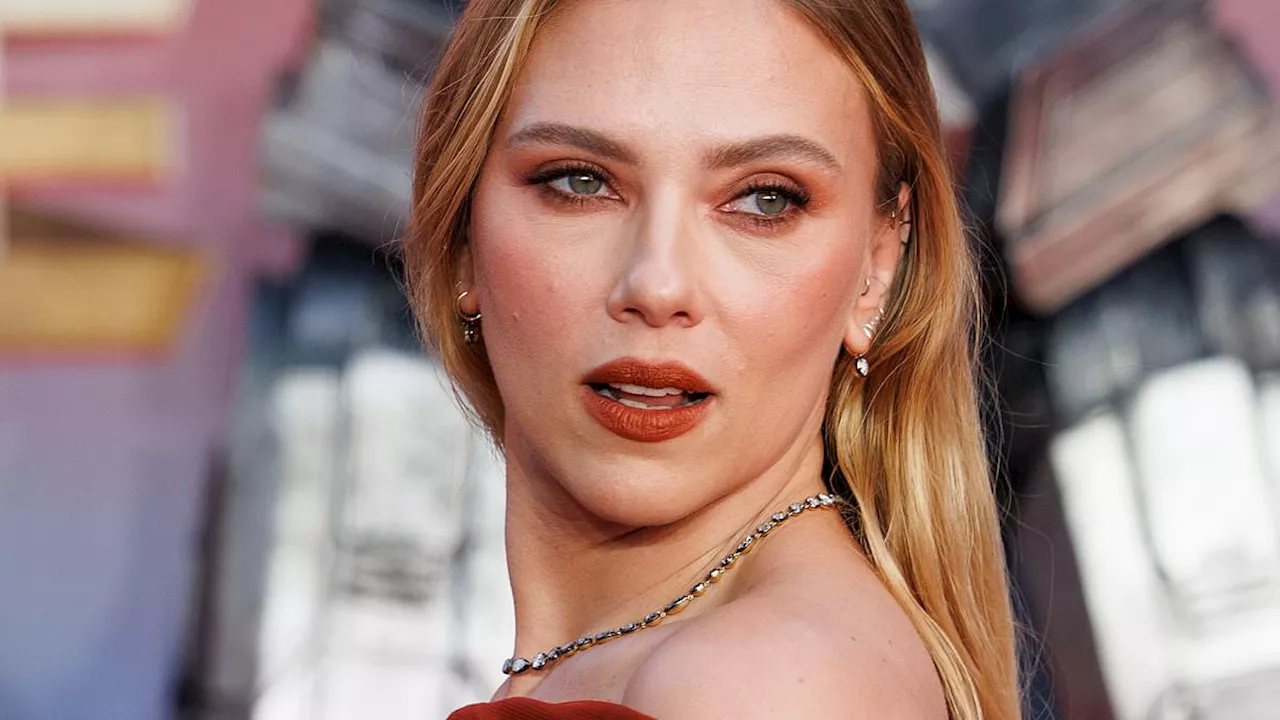 Scarlett Johansson puts on sizzling display in strapless red dress as she joins co-star Chris...